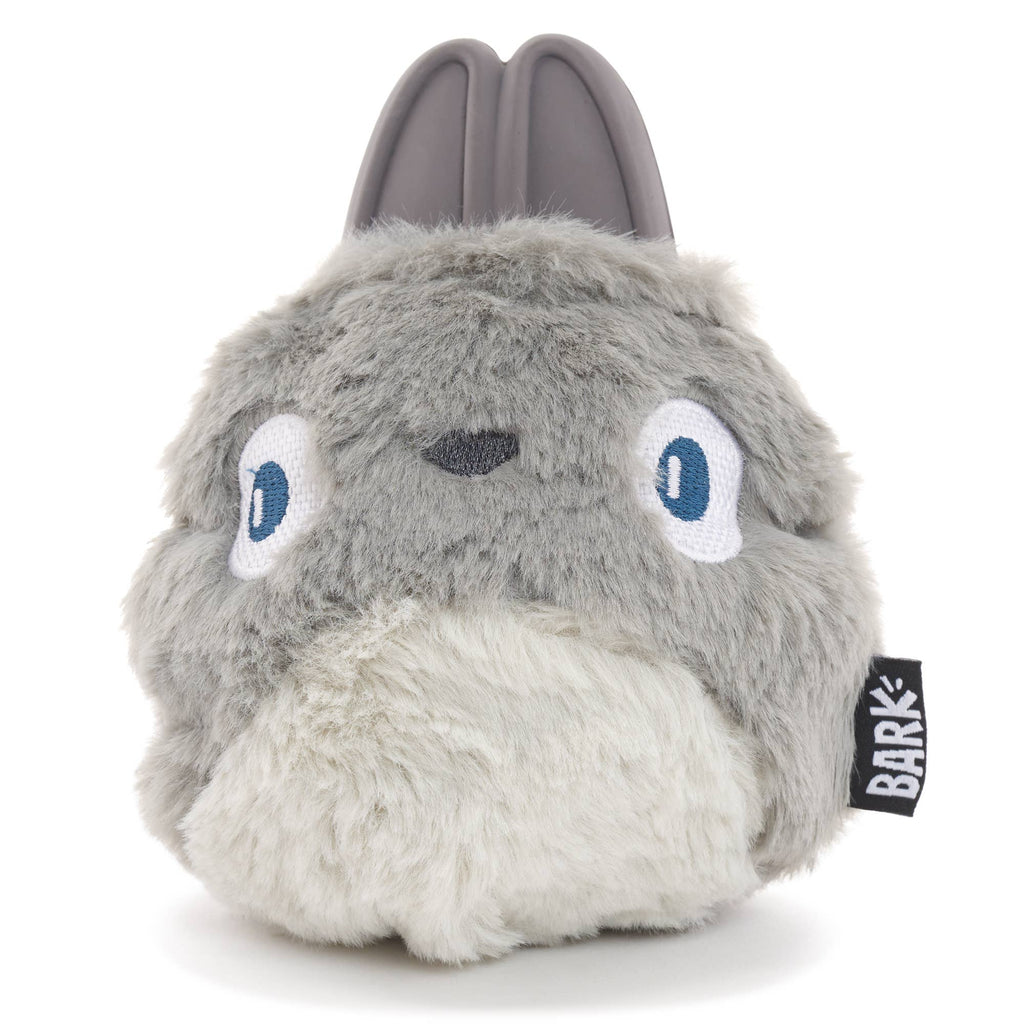 Gray BARK Hare Raiser rabbit dog toy with upright rubber ears, blue embroidered eyes, a fluffy white belly, and a rounded body.