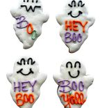 Two white ghost-shaped dog cookies with smiling faces and purple and orange lettering reading Hey Boo and Boo Y’all on a wooden plate.